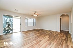 San Tan Valley house for rent - A spacious room with wooden flooring and a ceiling fan.