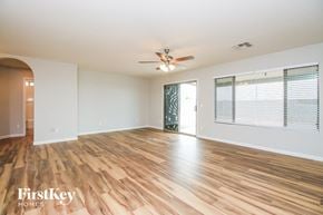 San Tan Valley house for rent - A room with wooden flooring and a ceiling fan.