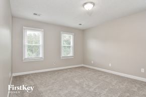 High Point house for rent - a bedroom with carpet and two windows
