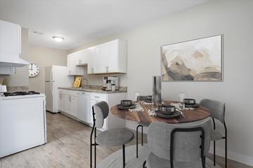 Madison Heights apartment for rent - A modern kitchen with a dining table set for four.