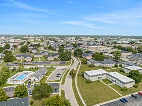 Madison Heights apartment for rent - A bird's eye view of a residential area with a swimming pool and a large white building.