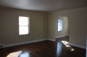 Spartanburg apartment for rent - an empty living room with wood floors and two windows