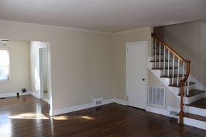 Spartanburg apartment for rent - an empty living room with a staircase and wood floors