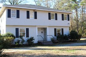 Spartanburg apartment for rent - a white house with black shutters and a front porch