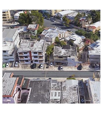 San Juan apartment for rent - A street view of a city with buildings and cars.