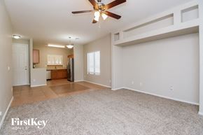 San Tan Valley house for rent - an empty living room with a ceiling fan and a kitchen