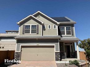 Commerce City house for rent - a house with a garage door and a