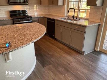 Commerce City house for rent - a kitchen with a granite counter top and a sink