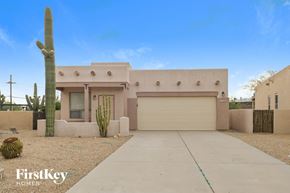 Tucson house for rent - a house with a driveway and a cactus in front of it