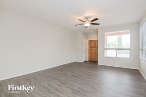 Tucson house for rent - a living room with a ceiling fan and a large window