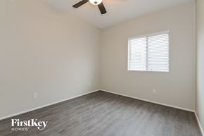 Tucson house for rent - the spacious bedroom with wood flooring and a ceiling fan
