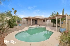 Tucson house for rent - a swimming pool in front of a house with a pool