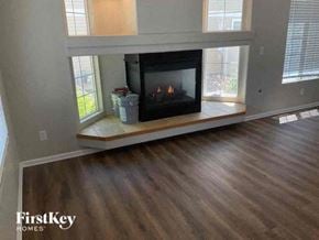 Denver house for rent - a living room with a fireplace and a wooden floor