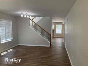 Denver house for rent - an empty living room with a staircase