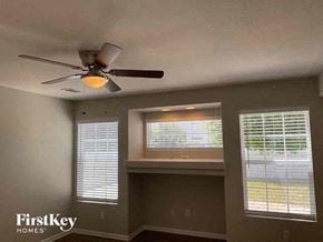 Denver house for rent - a living room with a ceiling fan and two windows