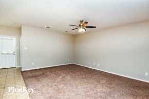 Fort Worth house for rent - A room with a ceiling fan and carpeted floor.