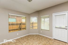 Fort Worth house for rent - A room with a tiled floor and a door with a window on the side.
