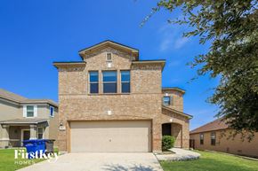 San Antonio house for rent - a house with a garage door and a lawn