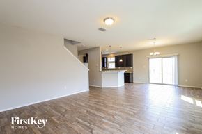 San Antonio house for rent - an empty living room and kitchen with wood flooring
