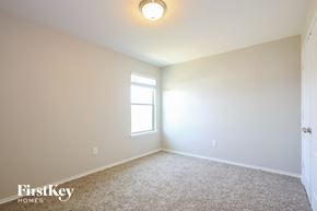 San Antonio house for rent - a bedroom with a window and a carpeted floor