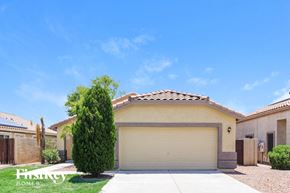 Glendale house for rent - a house with a garage door and a tree in front of it