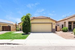 Glendale house for rent - a house with a garage door and a lawn