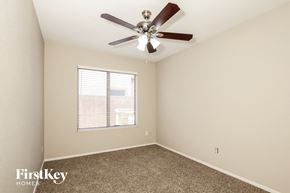 Glendale house for rent - a bedroom with a ceiling fan and a window
