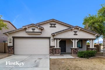 Laveen house for rent - a home with a garage door and a driveway