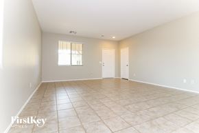 Laveen house for rent - a spacious living room with tile flooring and white walls