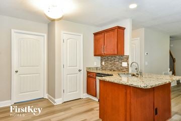 Clarksville house for rent - a kitchen with a granite counter top and