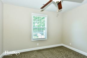 Clarksville house for rent - a bedroom with a window and a ceiling fan