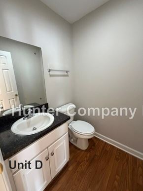 Wilson apartment for rent - A bathroom with a sink, toilet and mirror.