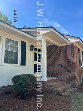 Wilson apartment for rent - A house with a white front door and brick steps leading to the entrance.