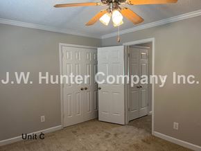 Wilson apartment for rent - A room with a ceiling fan and two doors, one of which is open.