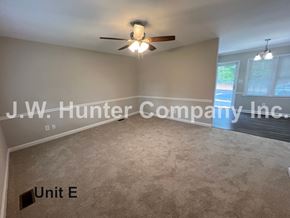 Wilson apartment for rent - A room with a ceiling fan and a sign that says "Unit E".