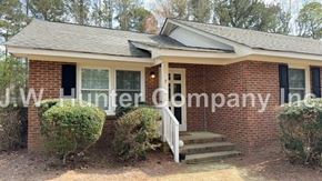 Wilson apartment for rent - A brick house with a white door and windows is for sale.