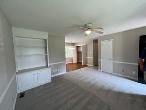 Wilson apartment for rent - A room with a ceiling fan and carpeted floor.