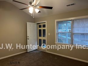 Wilson apartment for rent - A room with a ceiling fan and a door leading to a balcony.