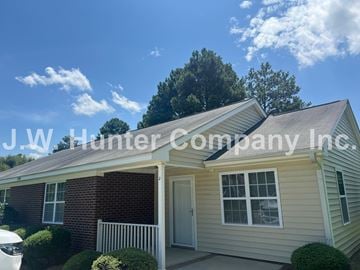 Wilson apartment for rent - A house with the text "J.W. Hunter Company Inc." superimposed on it.