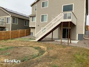 Colorado Springs house for rent - A house with a staircase leading to the entrance.