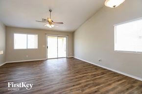 Phoenix house for rent - the spacious living room with wood flooring and a ceiling fan