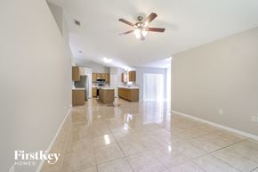 Poinciana house for rent - A spacious room with a ceiling fan and tiled flooring.