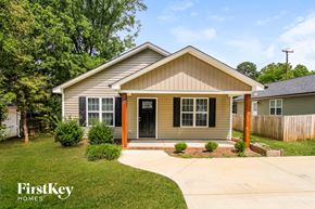 Concord house for rent - A house with a brown roof and a grey siding is shown.