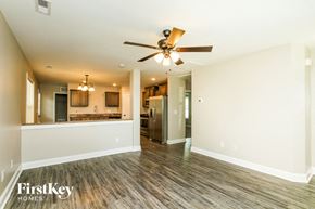 Concord house for rent - A spacious room with a ceiling fan and wooden flooring.