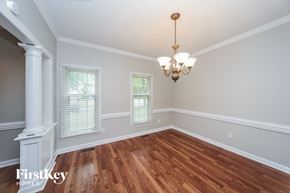 Collierville house for rent - an empty dining room with wood floors and a chandelier