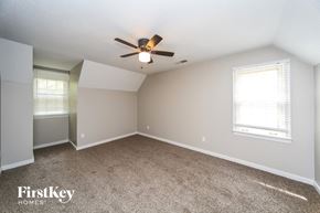 Collierville house for rent - an empty bedroom with a ceiling fan and window