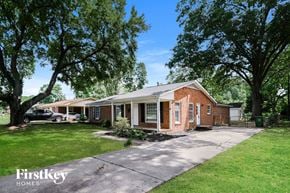 Charlotte house for rent - a brick house with a driveway and some trees