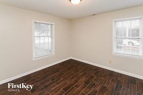 Charlotte house for rent - the living room of a home with wood flooring and two windows