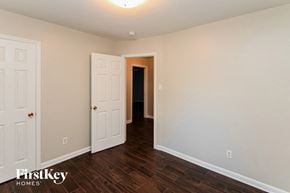 Charlotte house for rent - a bedroom with a white door and a hallway to a closet