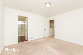Colorado Springs house for rent - A spacious room with a carpeted floor and a doorway leading to another room.